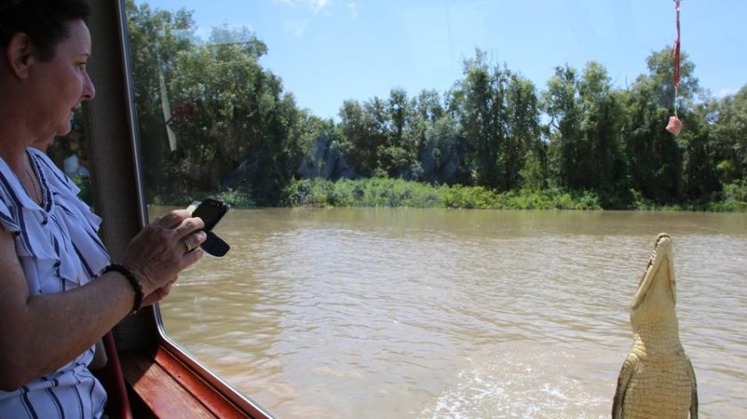 a man and a woman standing next to a body of water